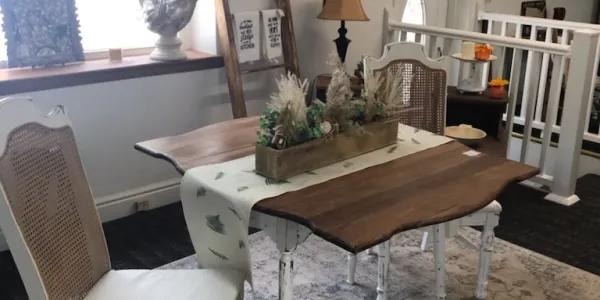 Farmhouse dining table with cane chairs and seasonal decor at The Buttonhole