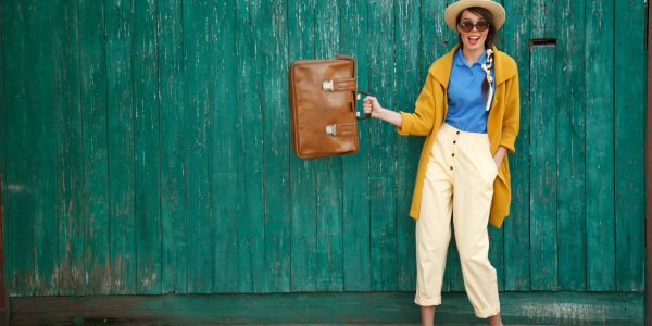 Stylishly dressed woman with vintage suitcase